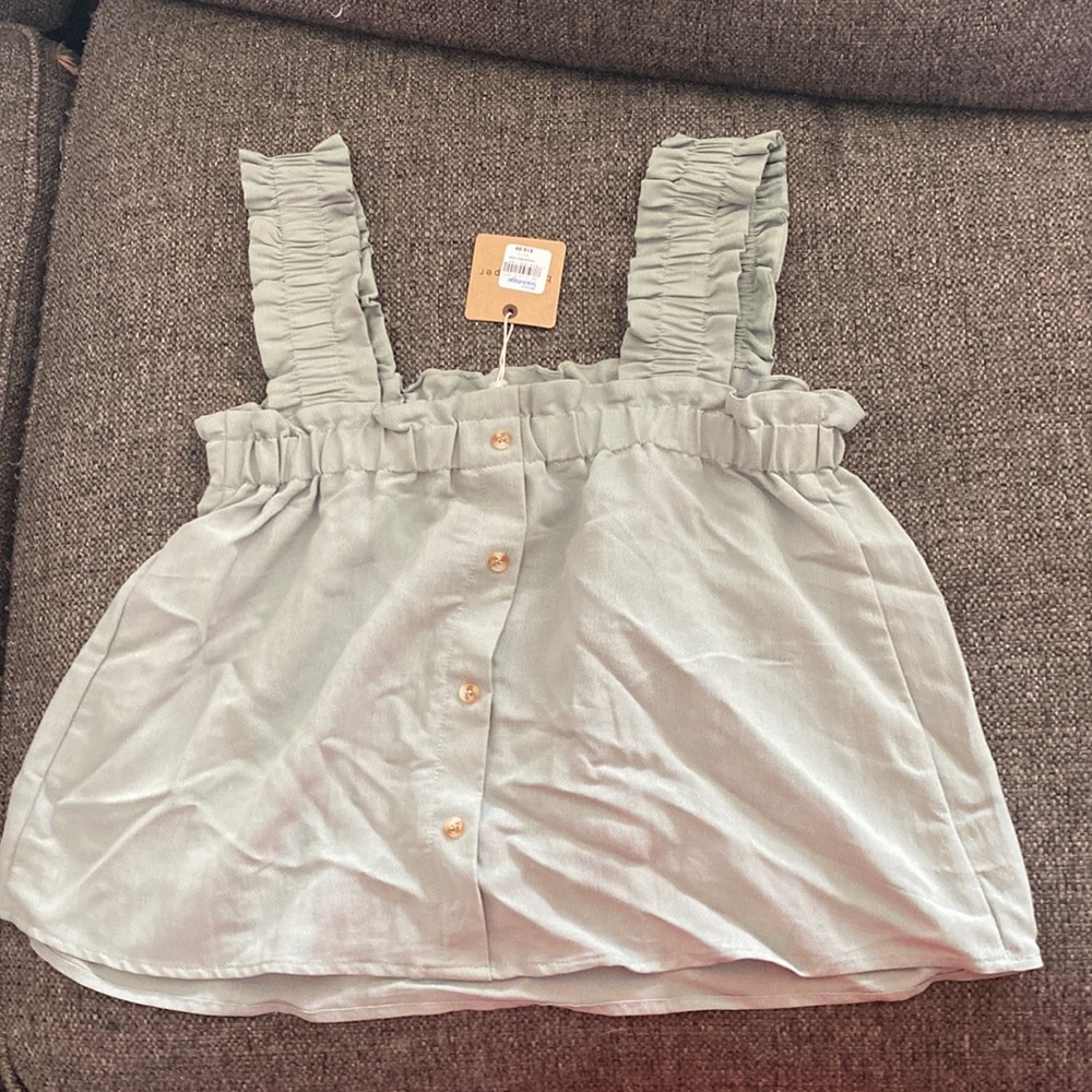 crop top, very lose fitting, light sage green. comes with a button